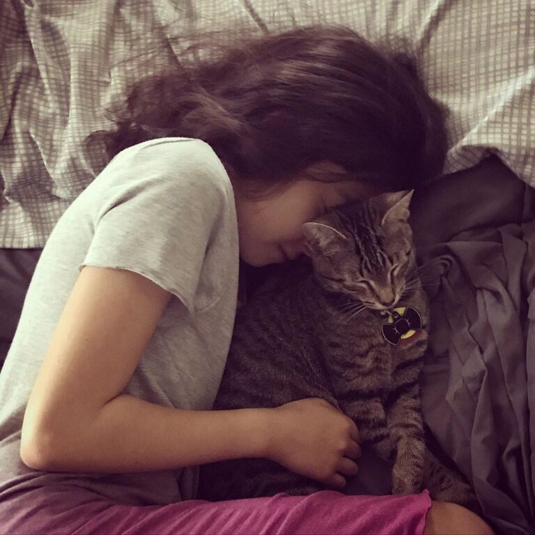 Someone got jealous of her brother’s snuggle time with the cat